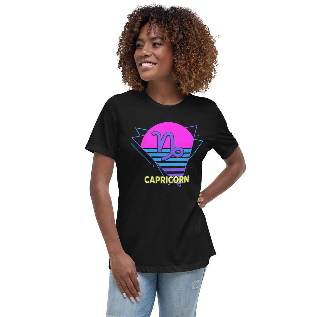 Woman wearing capricorn retro 80s astrology t-shirt with neon pink sun, styled with denim shorts