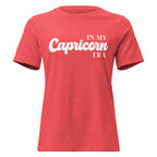 "In My Capricorn Era" zodiac graphic t-shirt, coral red, women's fitted astrology apparel, front flat lay