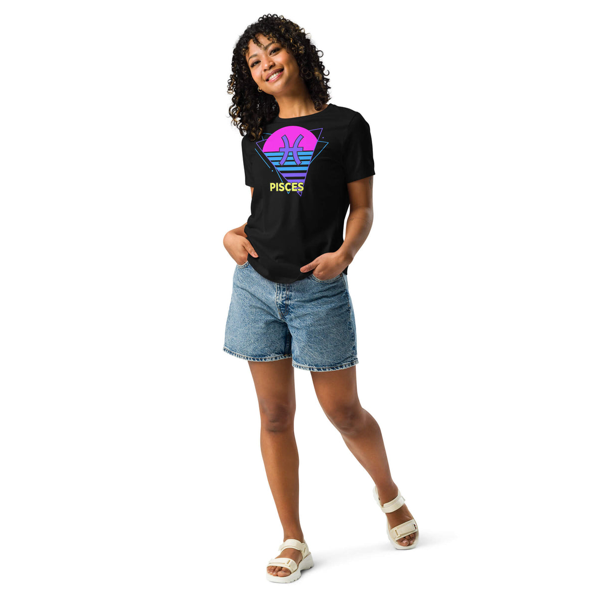 Person wearing a black t-shirt with a colorful design and denim shorts on a white background