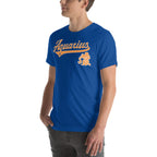 A man wearing a royal blue crewneck t-shirt with a vintage-style orange 'Aquarius' graphic and a zodiac sign on the chest, set against a plain white background.