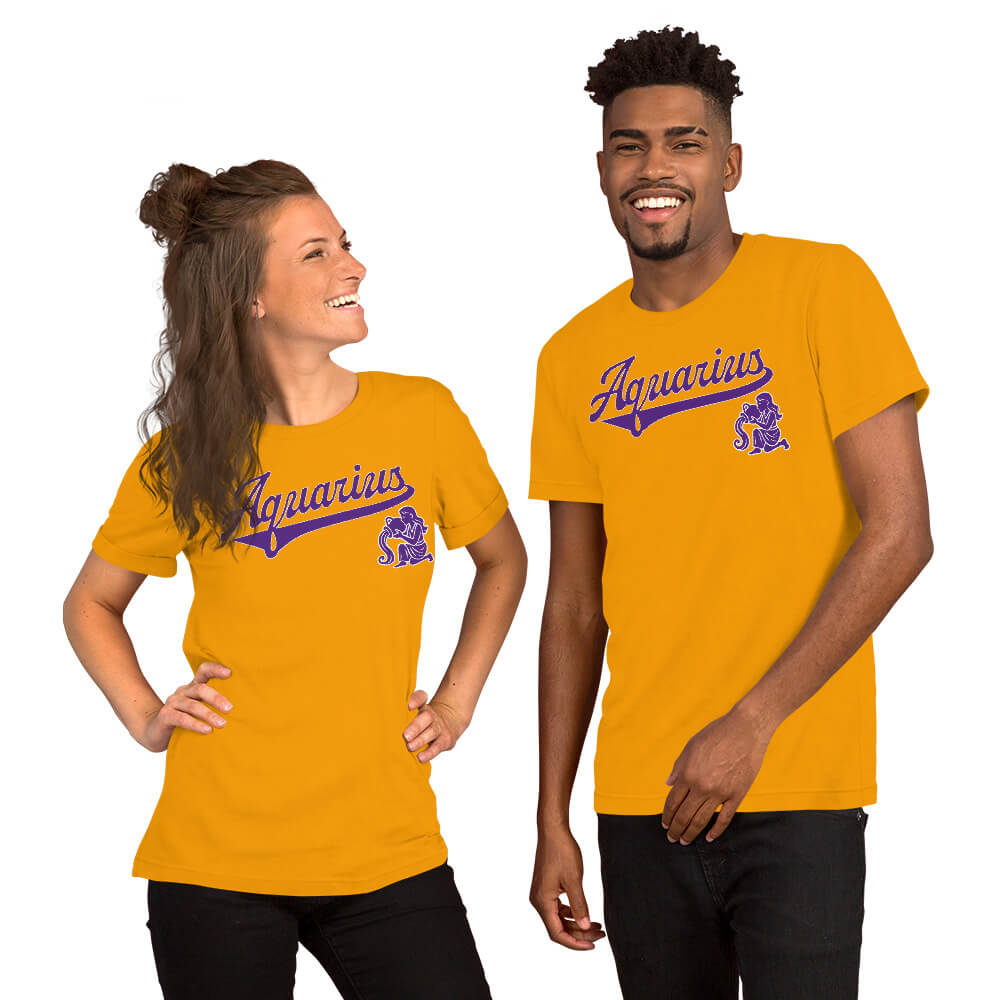 A man and a woman modeling matching gold short-sleeve t-shirts with a purple 'Aquarius' script and zodiac graphic on the chest, set against a plain white background.