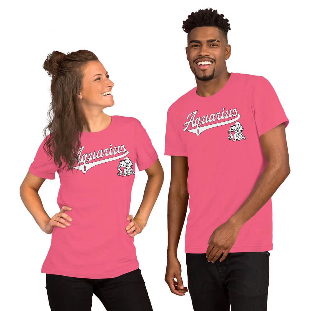 A man and a woman modeling matching bright pink short-sleeve t-shirts with a white 'Aquarius' script and a small zodiac-themed graphic on the left chest, against a plain white background.