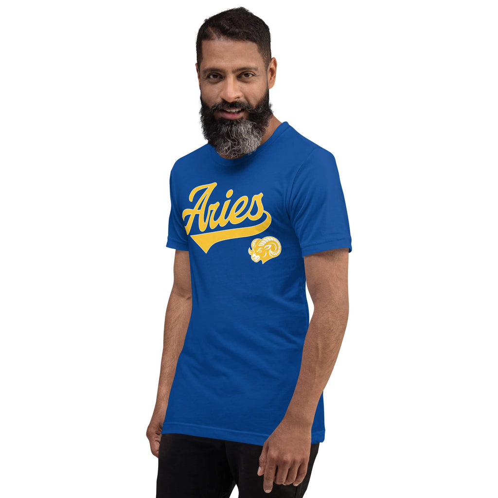 A man wearing a royal blue t-shirt with a gold 'Aries' graphic and a small ram illustration on the chest, set against a plain white background.