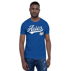 A man wearing a royal blue crewneck t-shirt with 'Aries' zodiac graphic on the chest, paired with blue jeans, against a plain white background.