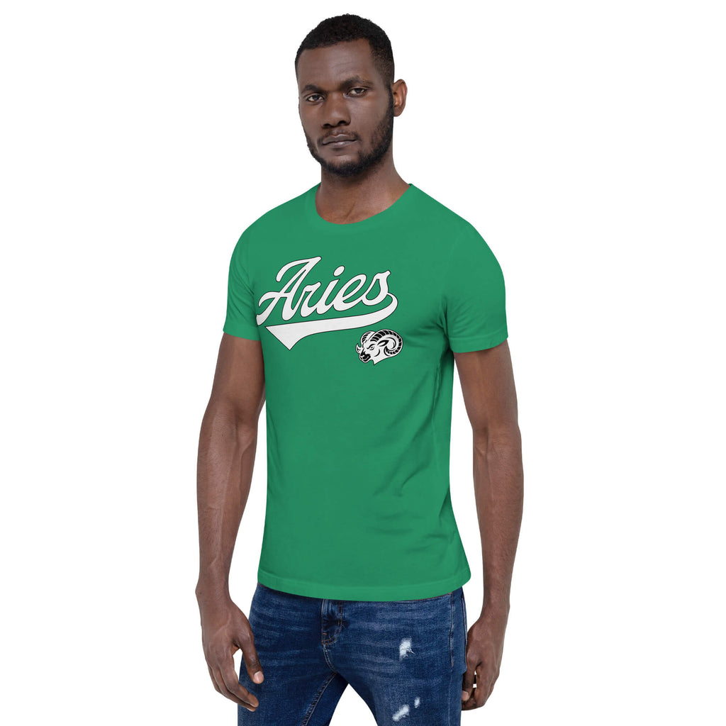 A man wearing a bright green crewneck t-shirt with 'Aries' in white script across the chest and a small ram graphic below it, paired with blue jeans, set against a plain white background.