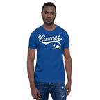 A man wearing a royal blue crewneck t-shirt with a white 'Cancer' script and crab graphic on the chest, paired with blue jeans, set against a plain white background.