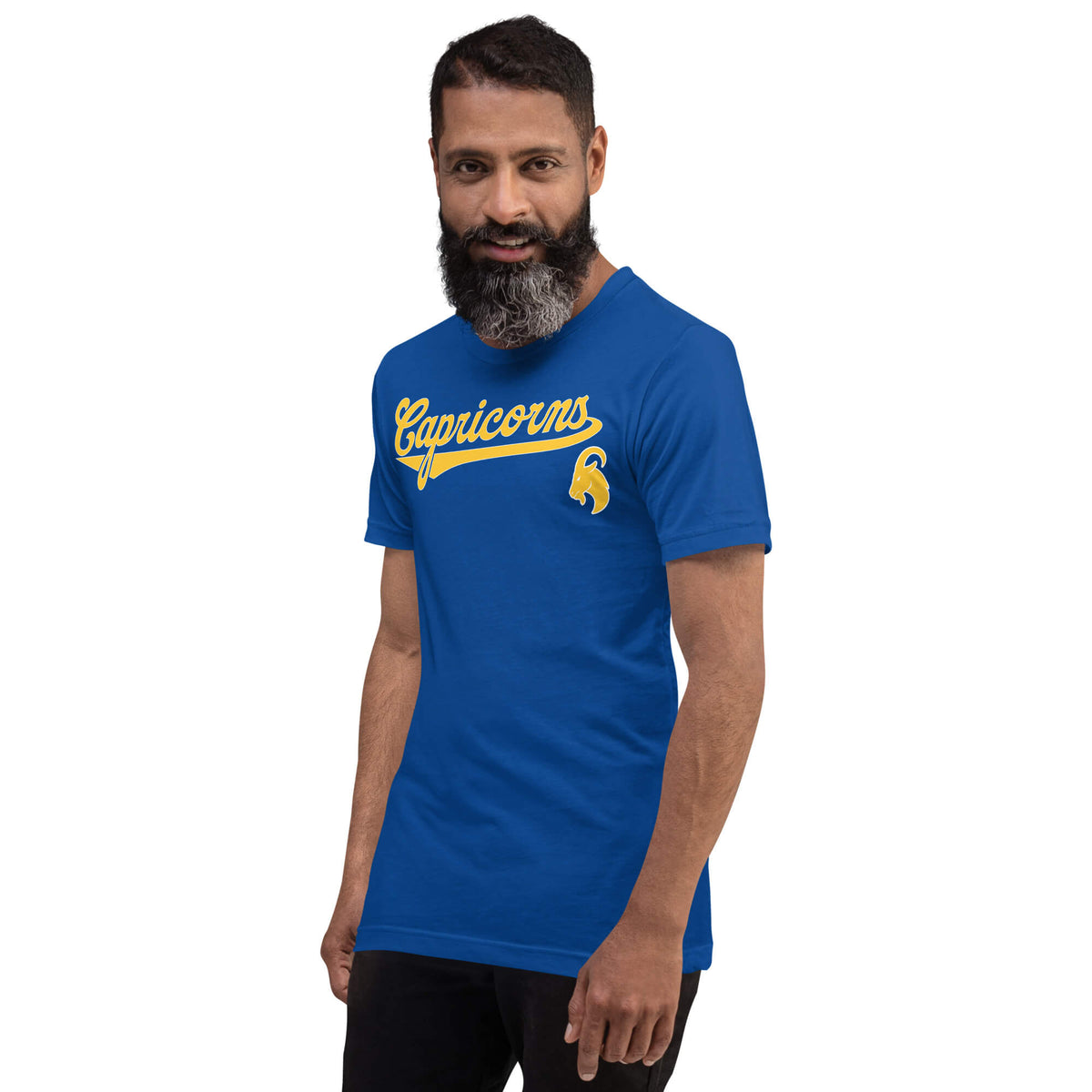 A man with a beard wearing a royal blue t-shirt with a gold 'Capricorns' graphic, set against a plain white background.