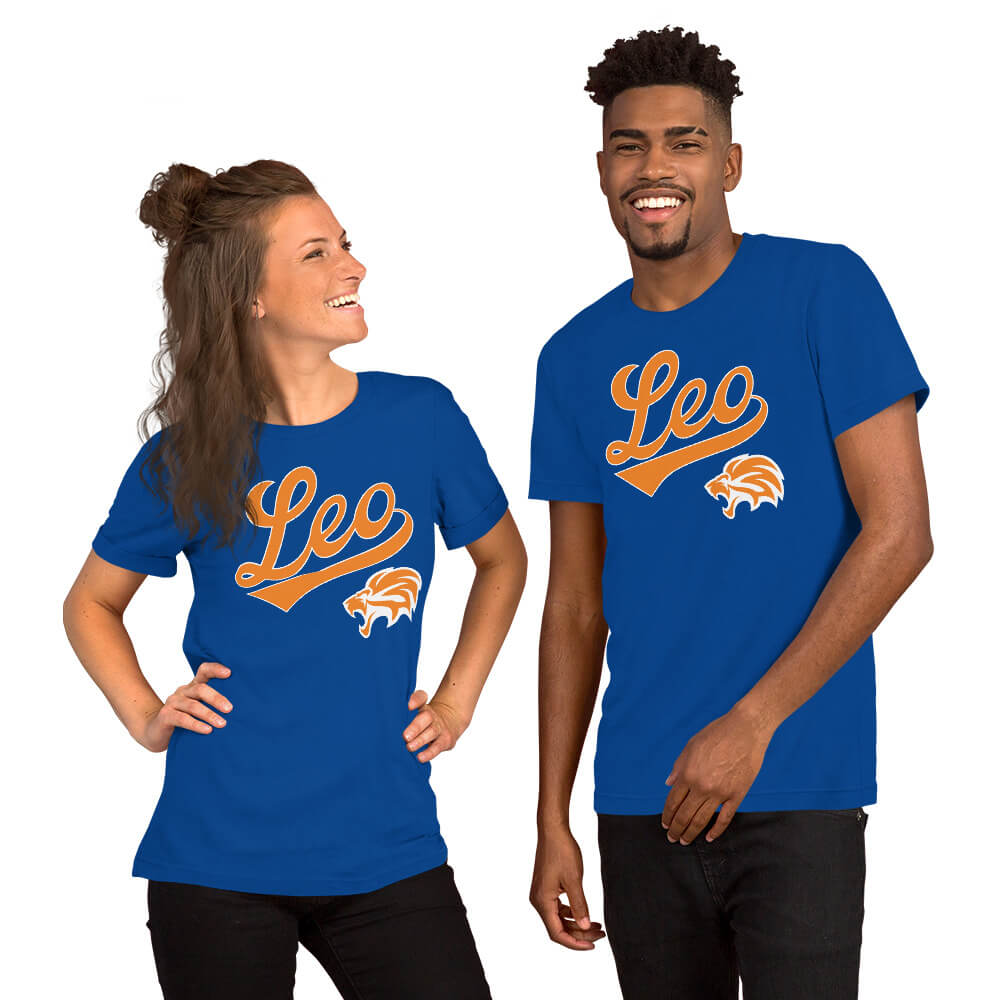 A man and a woman modeling matching royal blue t-shirts with a graphic that reads 'Leo' in orange script and a small orange-and-white lion head logo, shown against a plain white background.