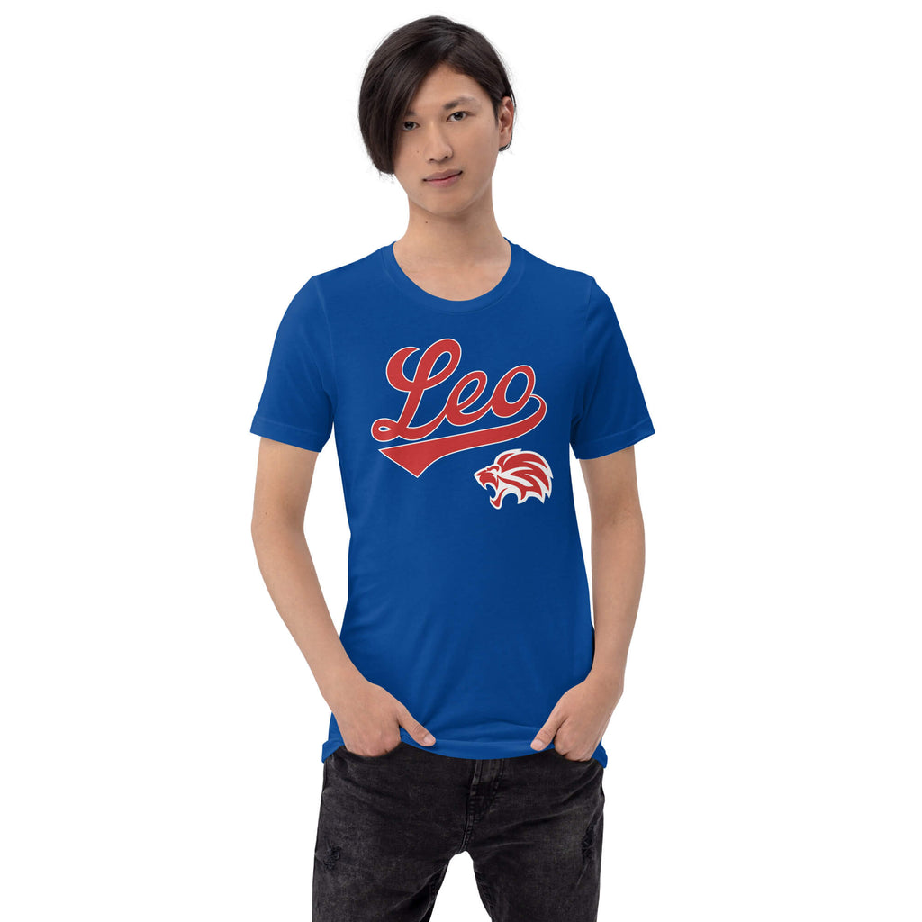 A man wearing a royal blue crewneck t-shirt with a red and white 'Leo' script and lion graphic on the chest, paired with dark jeans, against a plain white background.