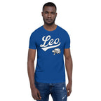 A man wearing a royal blue crewneck t-shirt with a white 'Leo' script and lion graphic on the chest, paired with blue jeans, set against a plain white background.