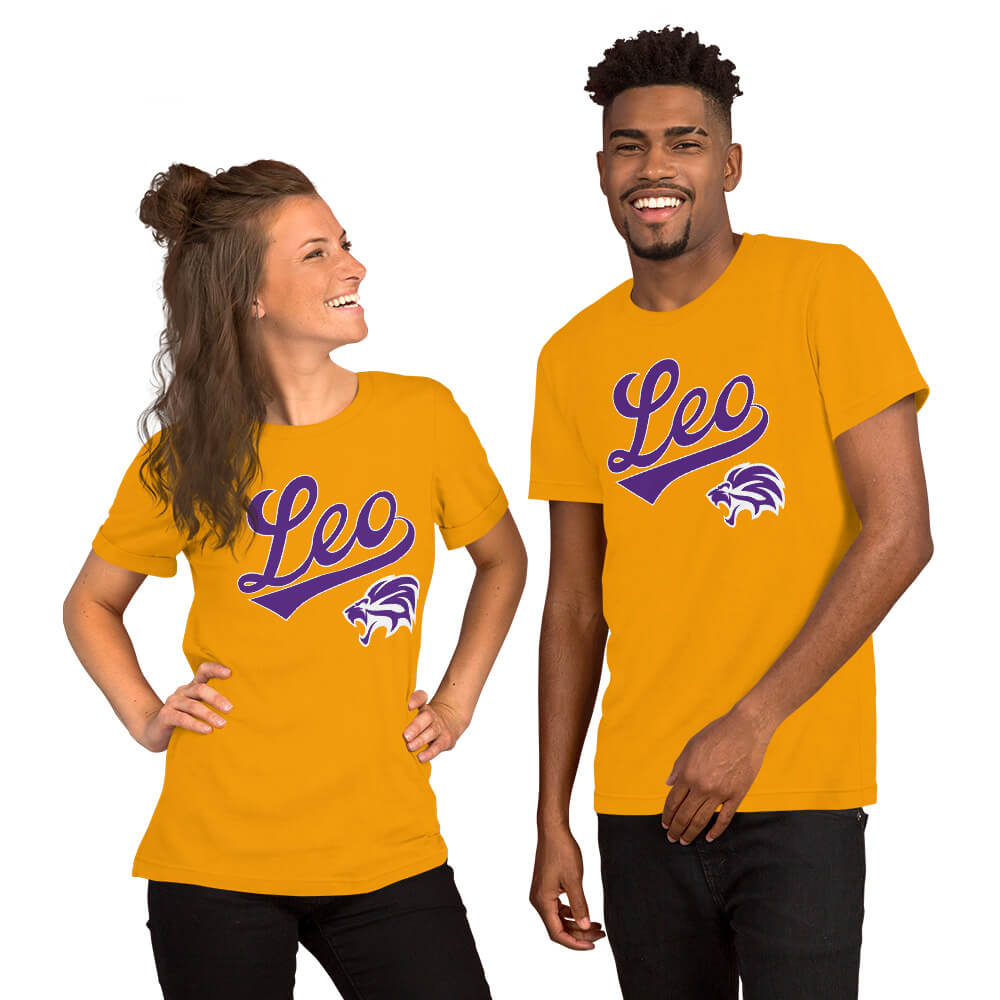 A man and a woman modeling matching gold t-shirts with a purple 'Leo' script and a wildcat graphic on the chest, set against a plain white background.