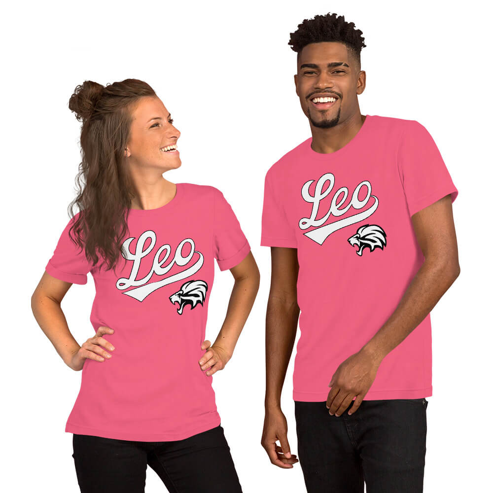 A man and a woman modeling matching bright pink t-shirts with a white 'Leo' script and a black-and-white animal head graphic on the chest, against a plain white background.
