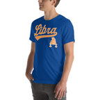 A man wearing a royal blue crewneck t-shirt with a gold 'Libra' graphic and zodiac symbol on the chest, shown from the waist up against a plain white background.