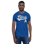 A man wearing a royal blue crewneck t-shirt with a white 'Libra' graphic and a small Libra zodiac symbol on the chest, paired with blue jeans, against a plain white background.