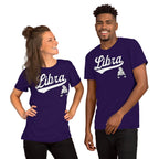 A man and a woman modeling matching purple t-shirts with a white 'Libra' script and a small Libra zodiac graphic on the front, set against a plain white background.