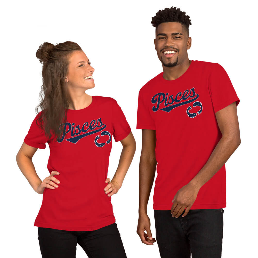 A man and a woman modeling matching red short-sleeve t-shirts with 'Pisces' written across the chest in navy blue script with a small red detail, set against a plain white background.