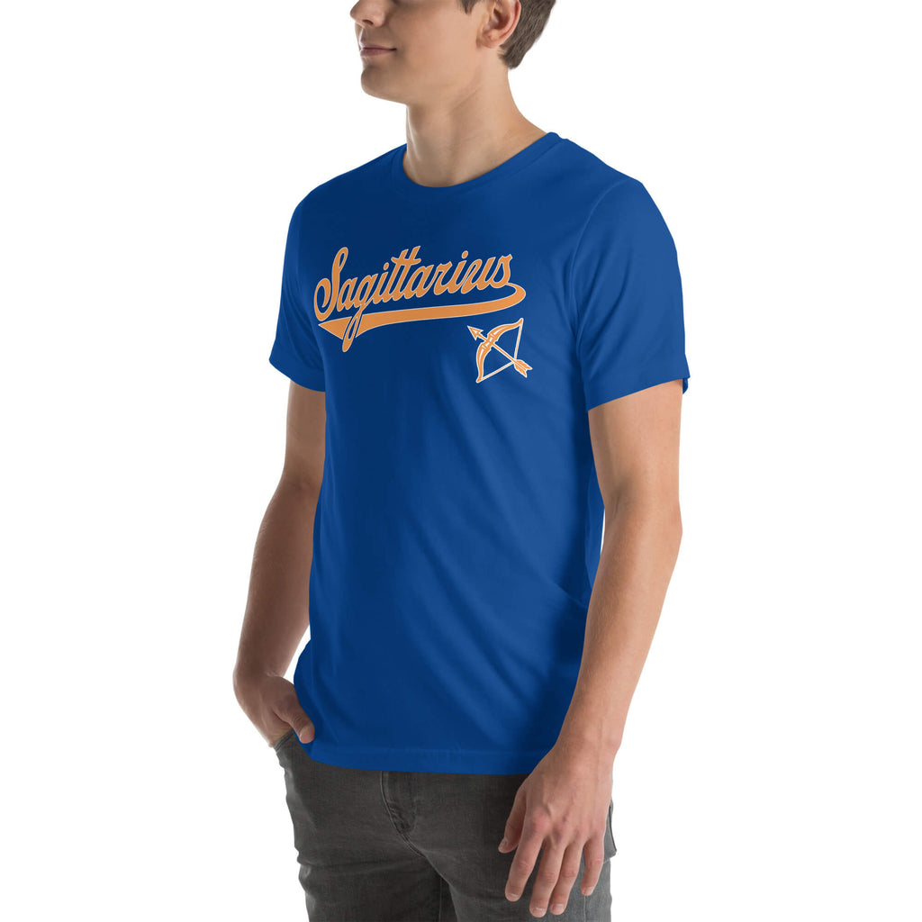 A man wearing a royal blue crewneck t-shirt with a vintage-style orange 'Sagittarius' graphic and a zodiac sign on the chest, set against a plain white background.