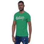 A man wearing a bright green crewneck t-shirt with a white 'Sagittarius' graphic across the chest, paired with blue jeans, set against a plain white background.