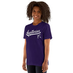 A woman with curly dark hair wearing a purple short-sleeve t-shirt with a white 'Sagittarius' script and bow graphic on the chest, shown against a plain white background.