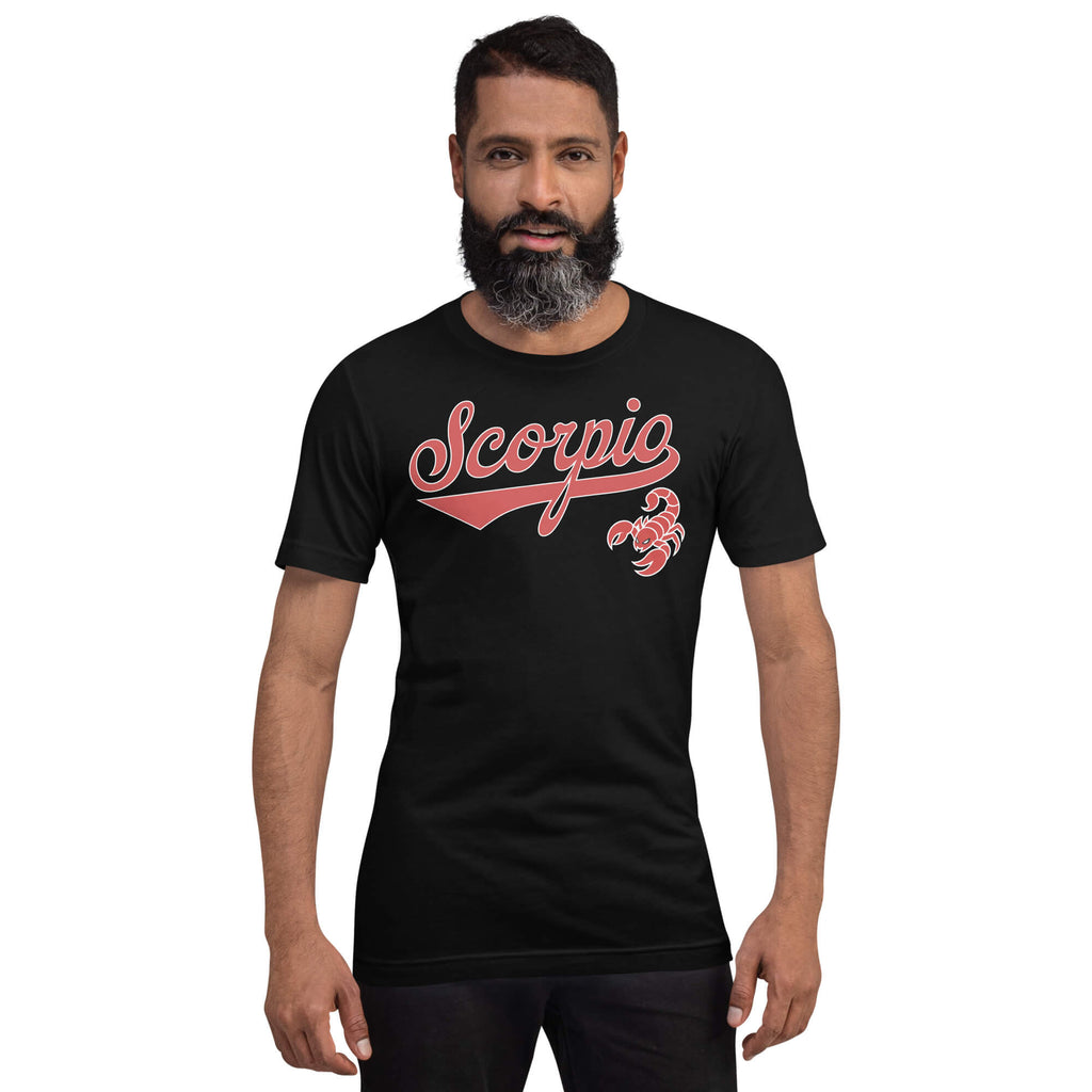 A man with a beard modeling a black crewneck t-shirt featuring a red 'Scorpio' script graphic and a red scorpion icon on the chest, set against a plain white background.
