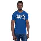 A man wearing a royal blue crewneck t-shirt with a white 'Scorpio' graphic and scorpion design on the chest, paired with blue jeans, set against a plain white background.