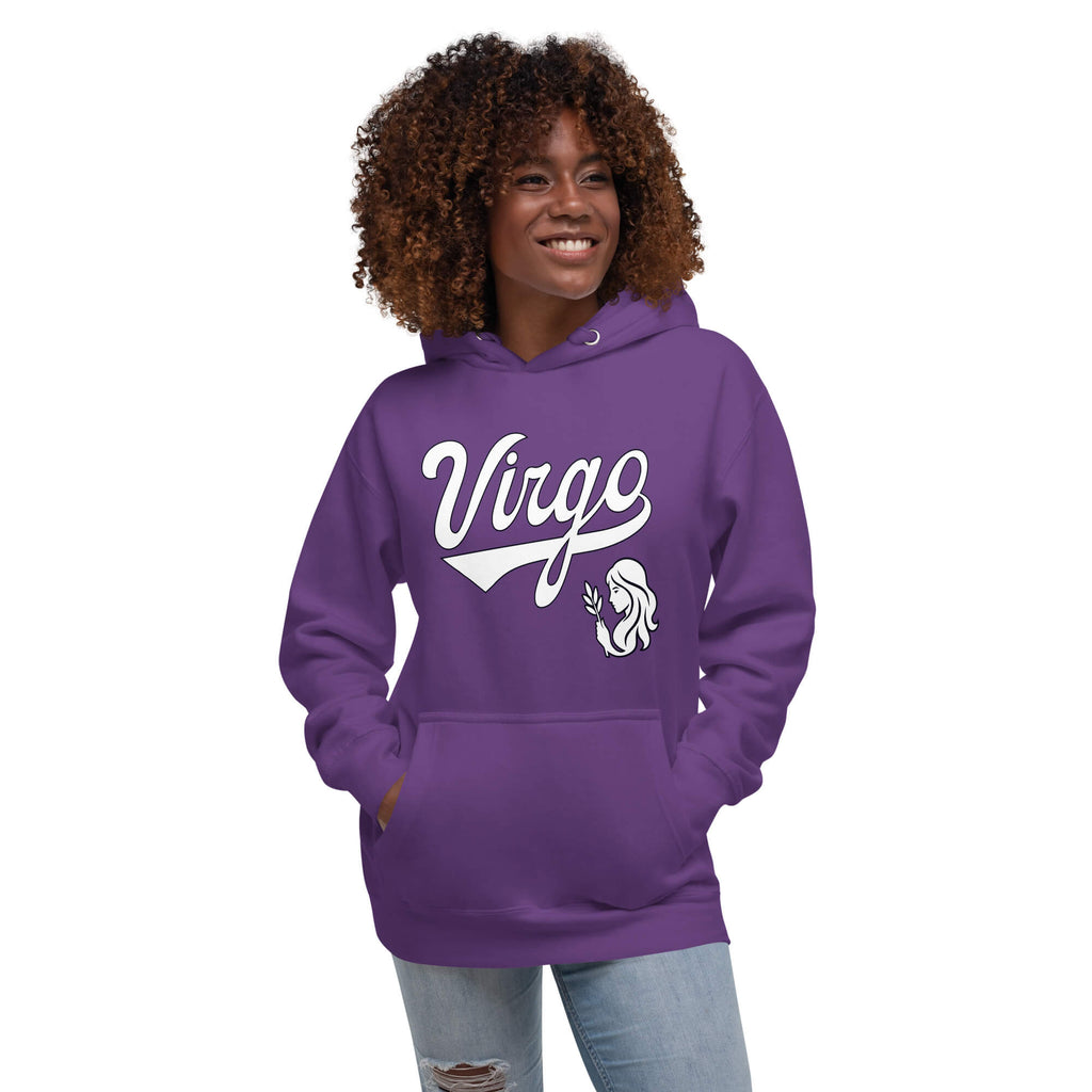 A woman with curly brown hair wearing a purple pullover hoodie with a white graphic that says 'Virgo' and a small illustration, paired with light blue jeans, against a plain white background.