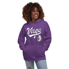 A woman with curly brown hair wearing a purple pullover hoodie with a white graphic that says 'Virgo' and a small illustration, paired with light blue jeans, against a plain white background.